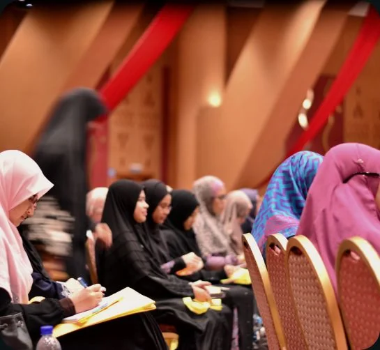 Attendees taking notes during a Being ME conference session