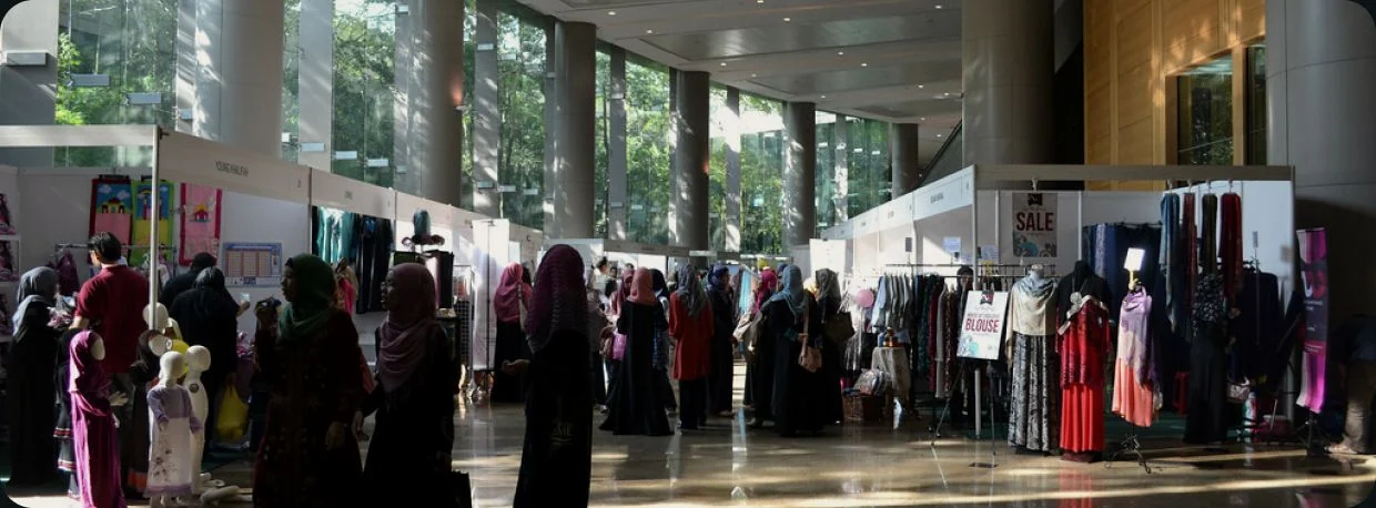 Stalls and shoppers at the Being ME marketplace